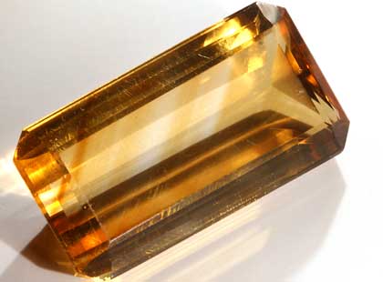 Citrine emerald cut faceted gemstone.